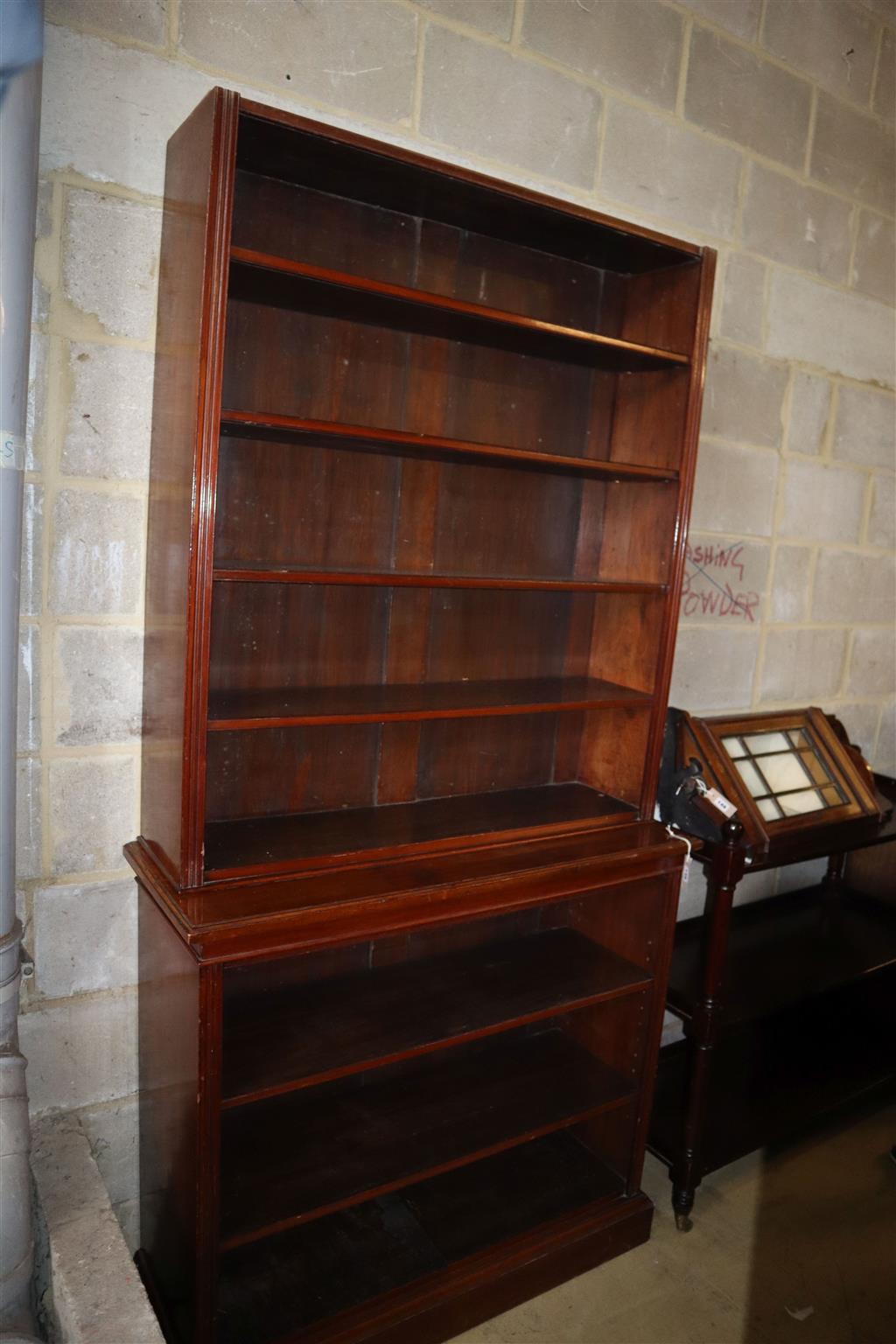 A late Victorian mahogany open fronted two section bookcase (lacking cornice), width 107cm, depth 39cm, height 216cm